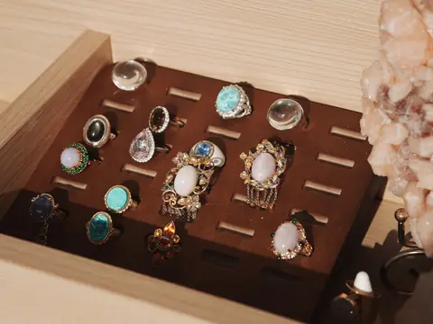 Vintage gemstone rings set in a wooden ring tray