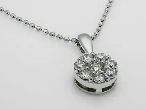 A diamond cluster pendant in white gold on a fine ball chain