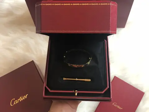A Cartier Love bracelet in its red Cartier box with the maker's papers