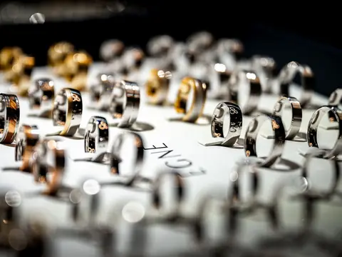 Rows of gold and diamond rings set out on a jeweler's display counter